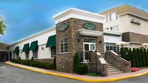 A building with a stone facade and green awnings, labeled "Palmer's Crossing Restaurant."