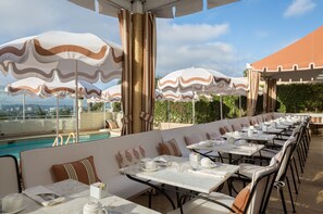 Guests can dine al fresco in style, surrounded by a serene pool area.