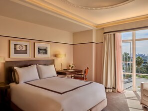 Relax in this inviting room with a large bed, framed artwork, and a city view.
