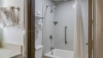 A modern bathroom with a shower, toilet, and a towel rack.