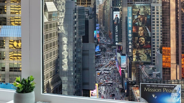 A view of Times Square with tall buildings and billboards.