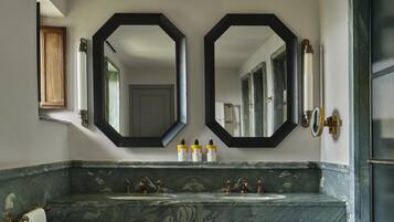 A bathroom with two sinks, a large mirror, and a wooden cabinet.