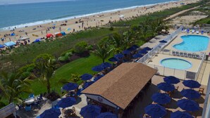 A resort with a pool, beach, and outdoor seating area. - Carousel Resort Hotel & Condominiums (Ocean City)