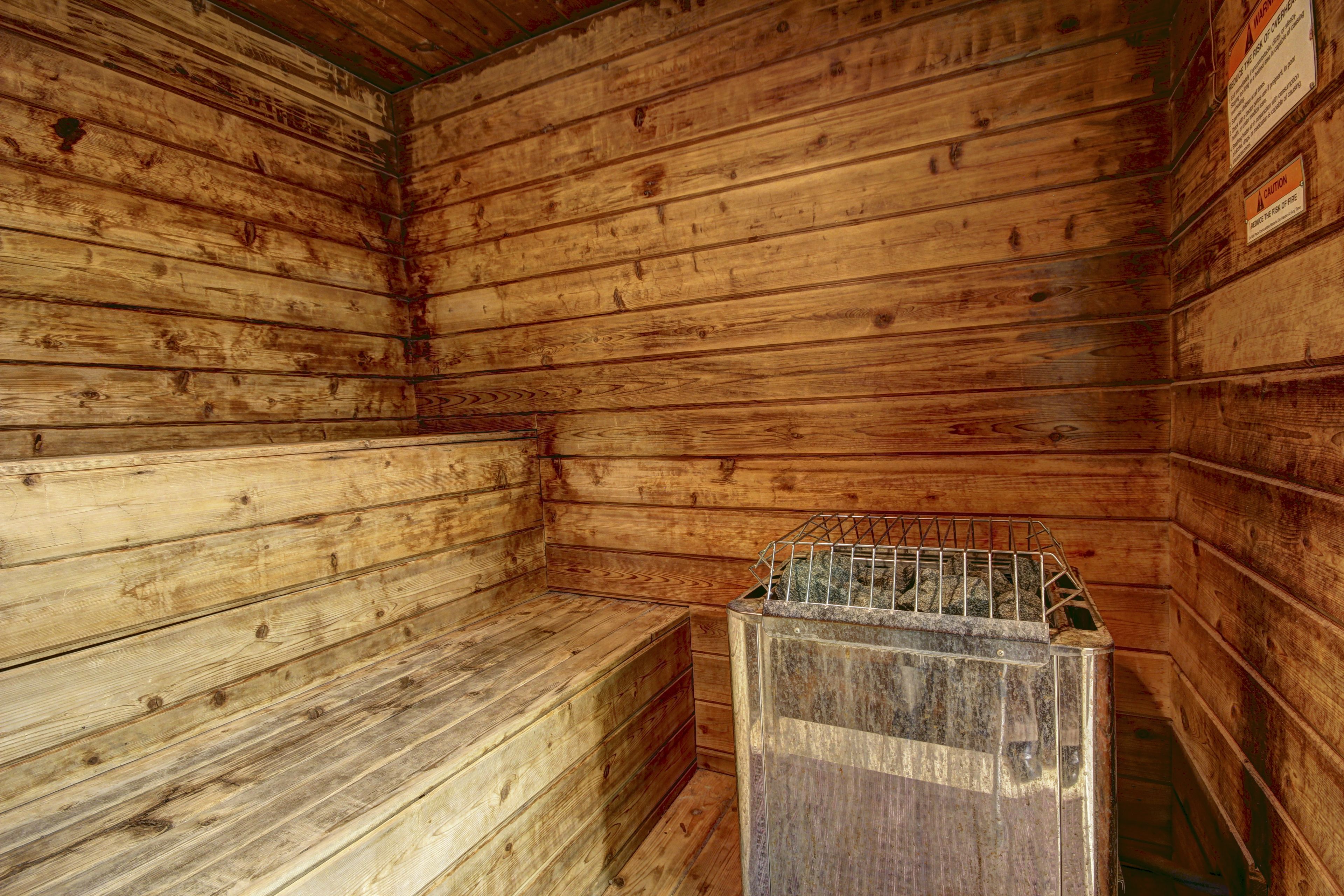 A sauna room with wooden walls and benches.