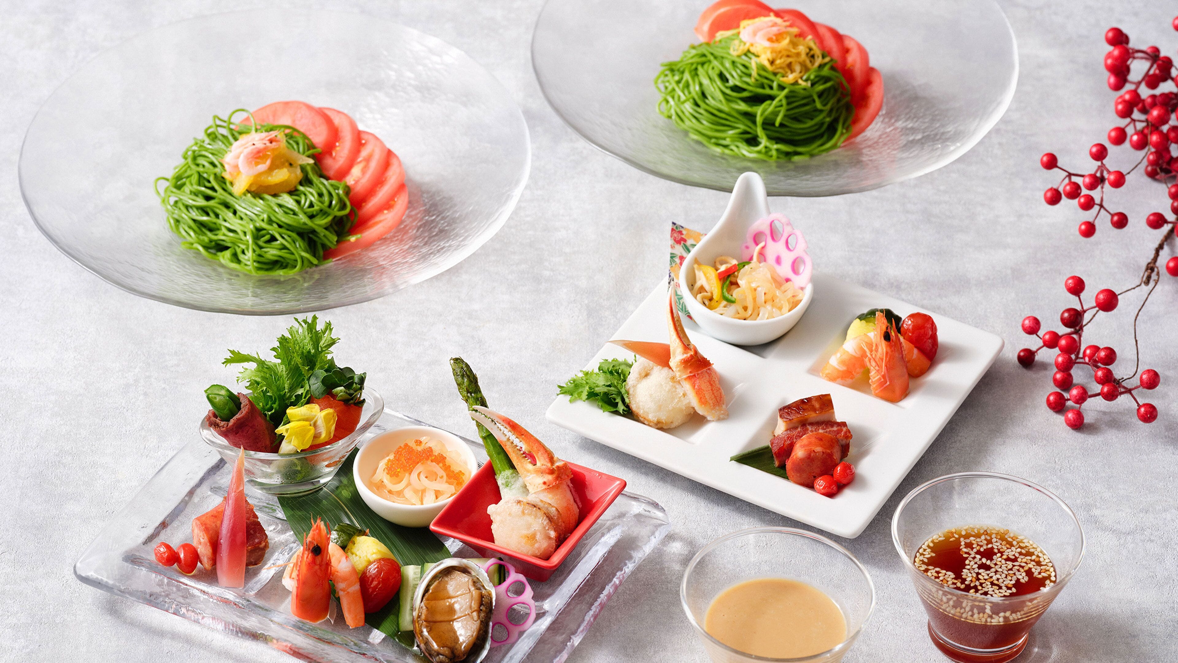A variety of dishes on a table, including seafood, vegetables, and a bowl of noodles.