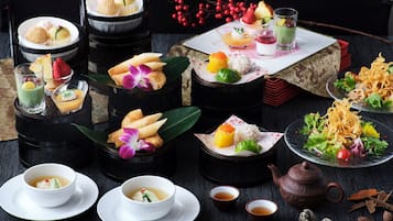 A variety of traditional Asian desserts and beverages arranged on a table.