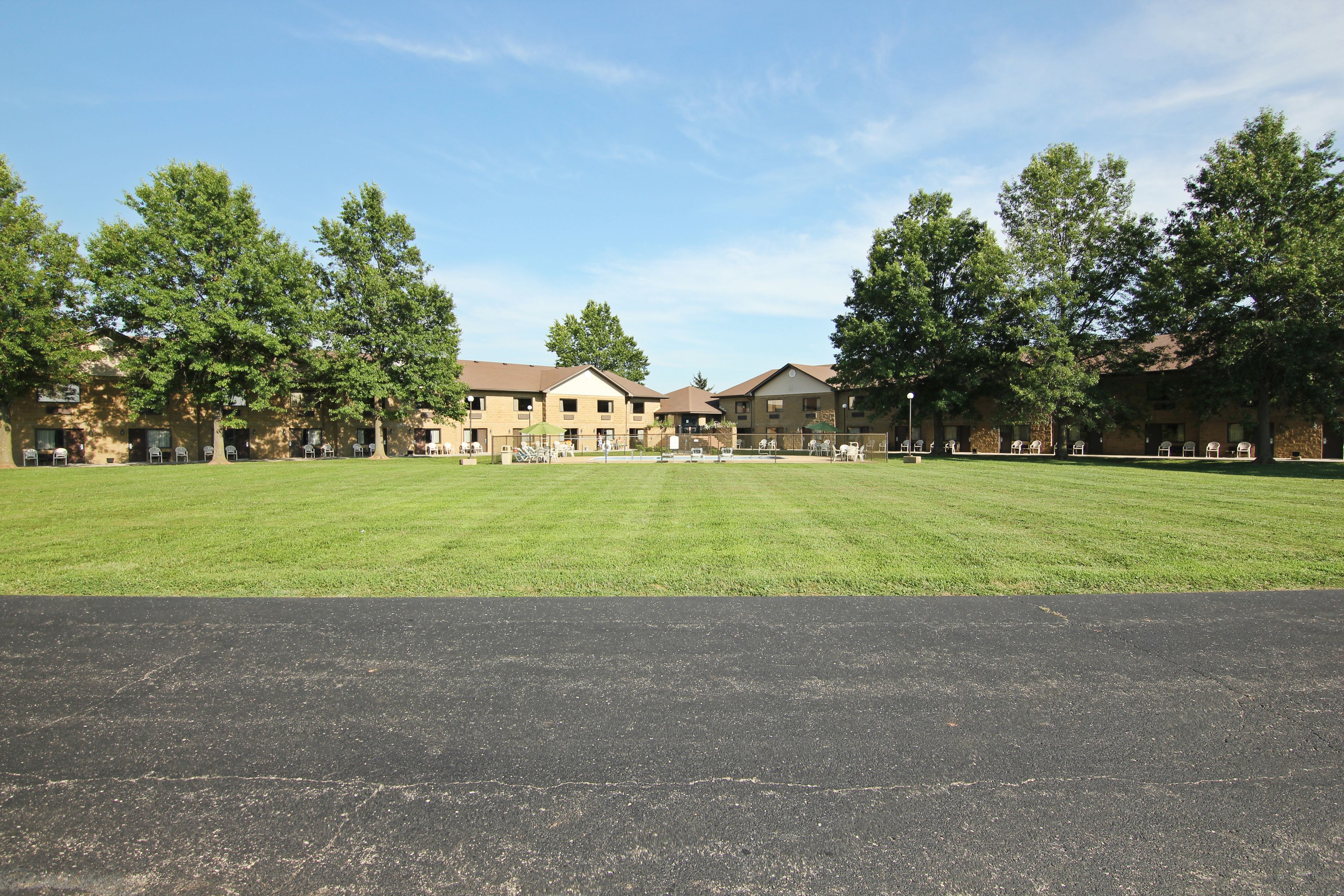 A large, open grassy area with a building in the background.