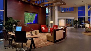 A modern lobby with a large map display, comfortable seating, and a spacious layout.