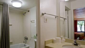 A bathroom with a bathtub, toilet, and sink.