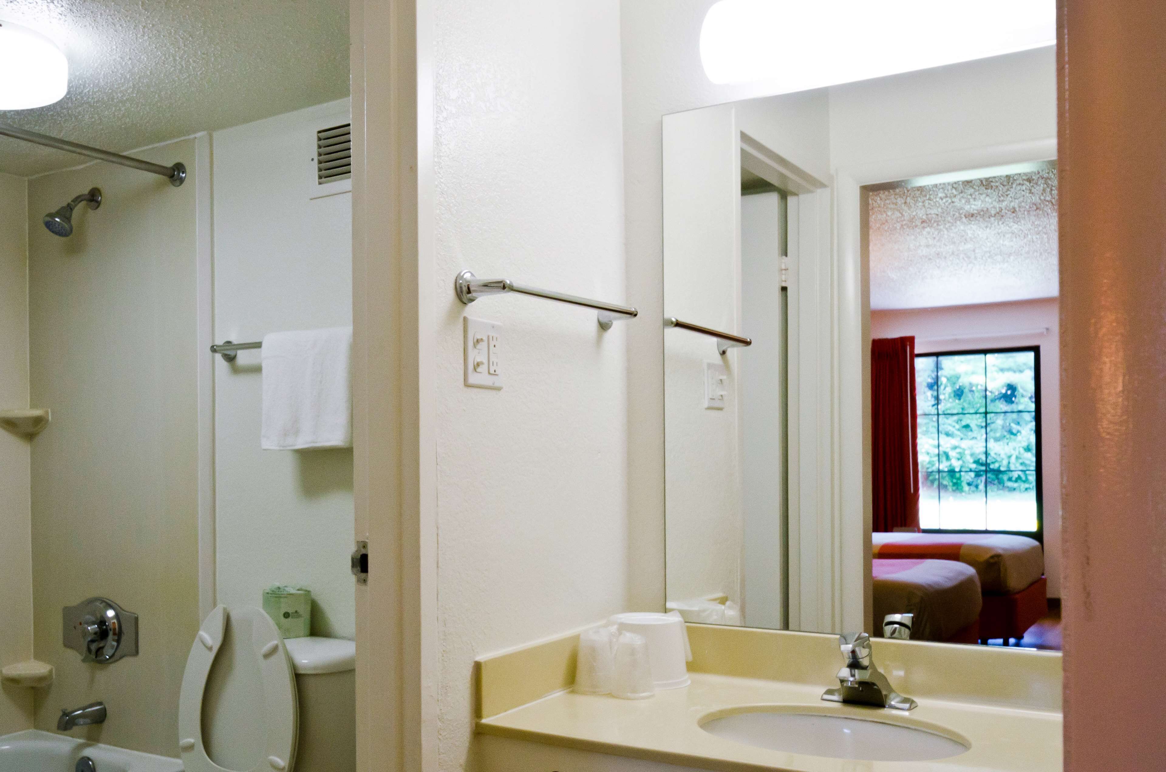 A bathroom with a toilet, sink, and shower.