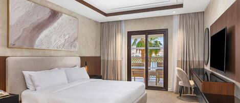 A hotel room with a large bed, a flat-screen TV, a desk, and a view of the outdoors.