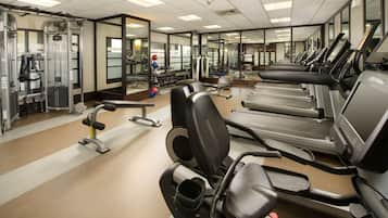 A gym with treadmills, weight machines, and mirrors.