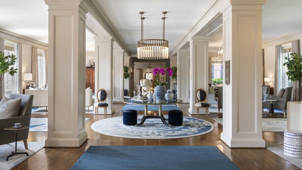 A spacious, elegantly decorated interior with a central round table, high ceilings, and classic architectural columns. - The Carolina Inn, a Destination by Hyatt Hotel (Chapel Hill)