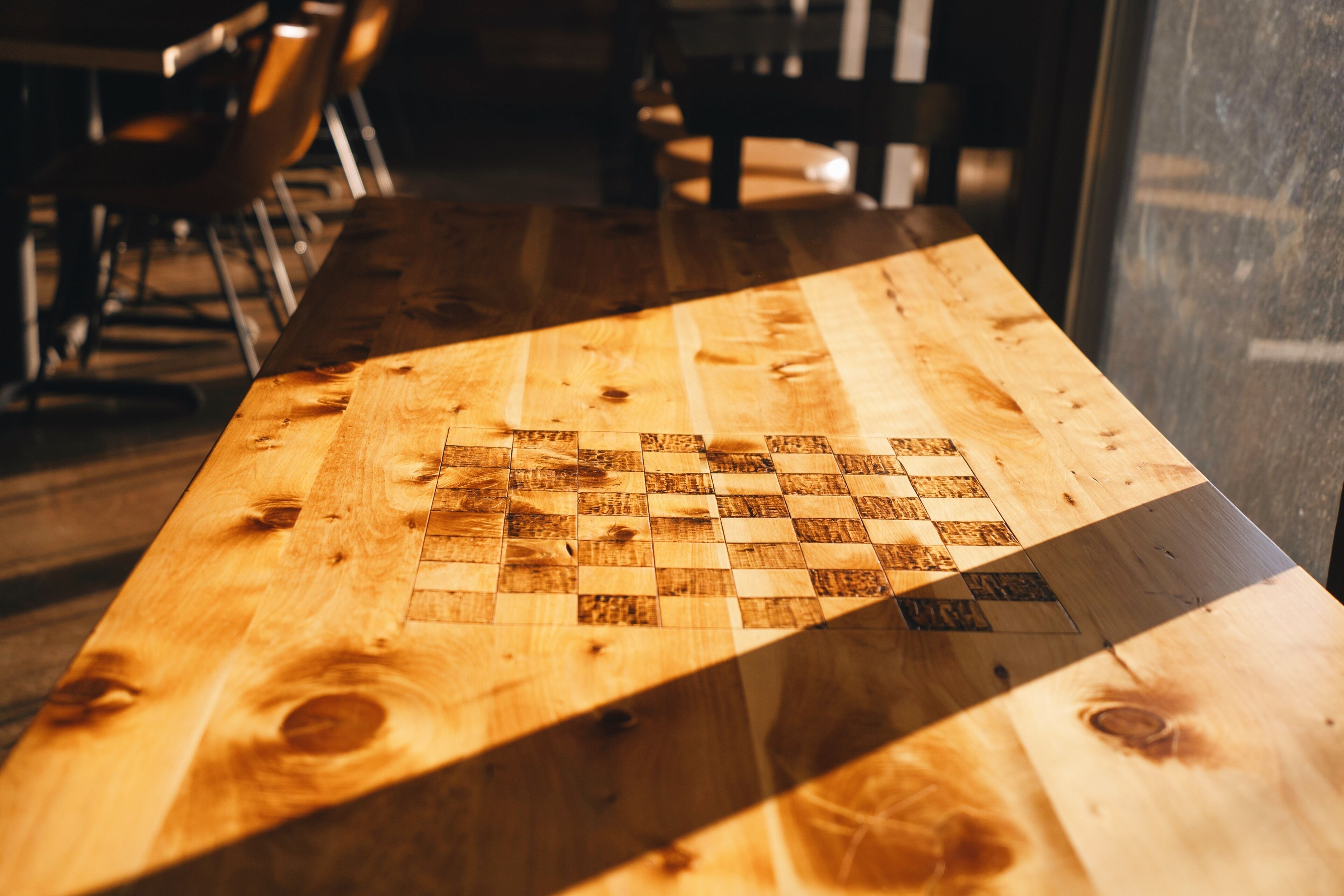 A wooden table with a chessboard pattern.