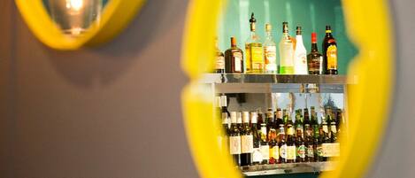 A bar area with shelves of various liquor bottles.
