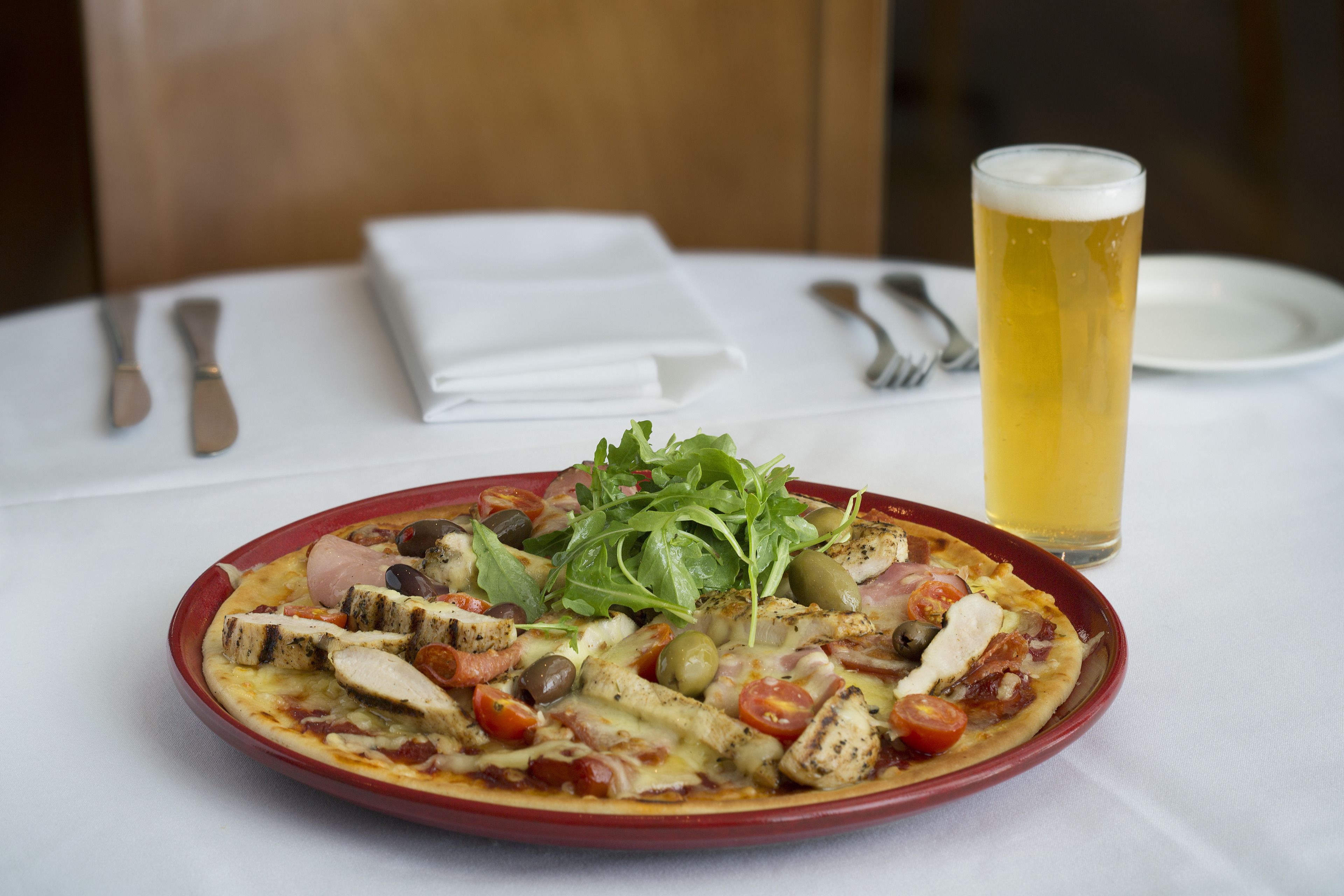 A meal with a glass of beer on a table.
