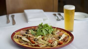 A meal with a glass of beer on a table.