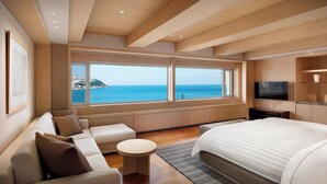 A modern hotel room with a large bed, a sofa, a small round table, and a TV. - The Westin Josun Busan (Busan)