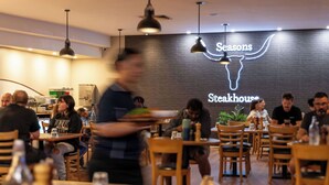A restaurant interior with tables, chairs, and a neon sign reading "Seasons Steakhouse." - The Lodge Motel, Newman (Newman)