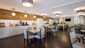 A spacious restaurant with multiple dining areas, wooden accents, and modern lighting fixtures.