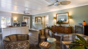 A spacious living room with a large ceiling fan, a wooden coffee table, and a sofa.