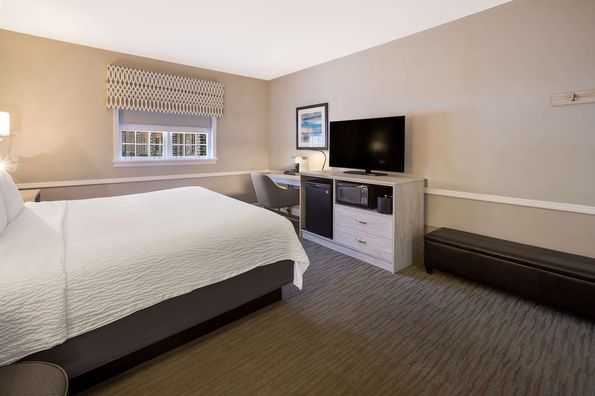 Premium bedding, desk, laptop workspace, blackout drapes