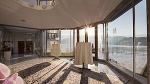 A spacious room with large windows, a patterned carpet, and a view of a mountainous landscape. - Grand Hotel Toplice - Sava Hotels & Resorts (Bled)
