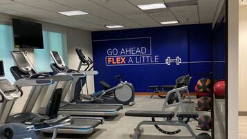 A gym with treadmills, stationary bikes, and weight equipment.