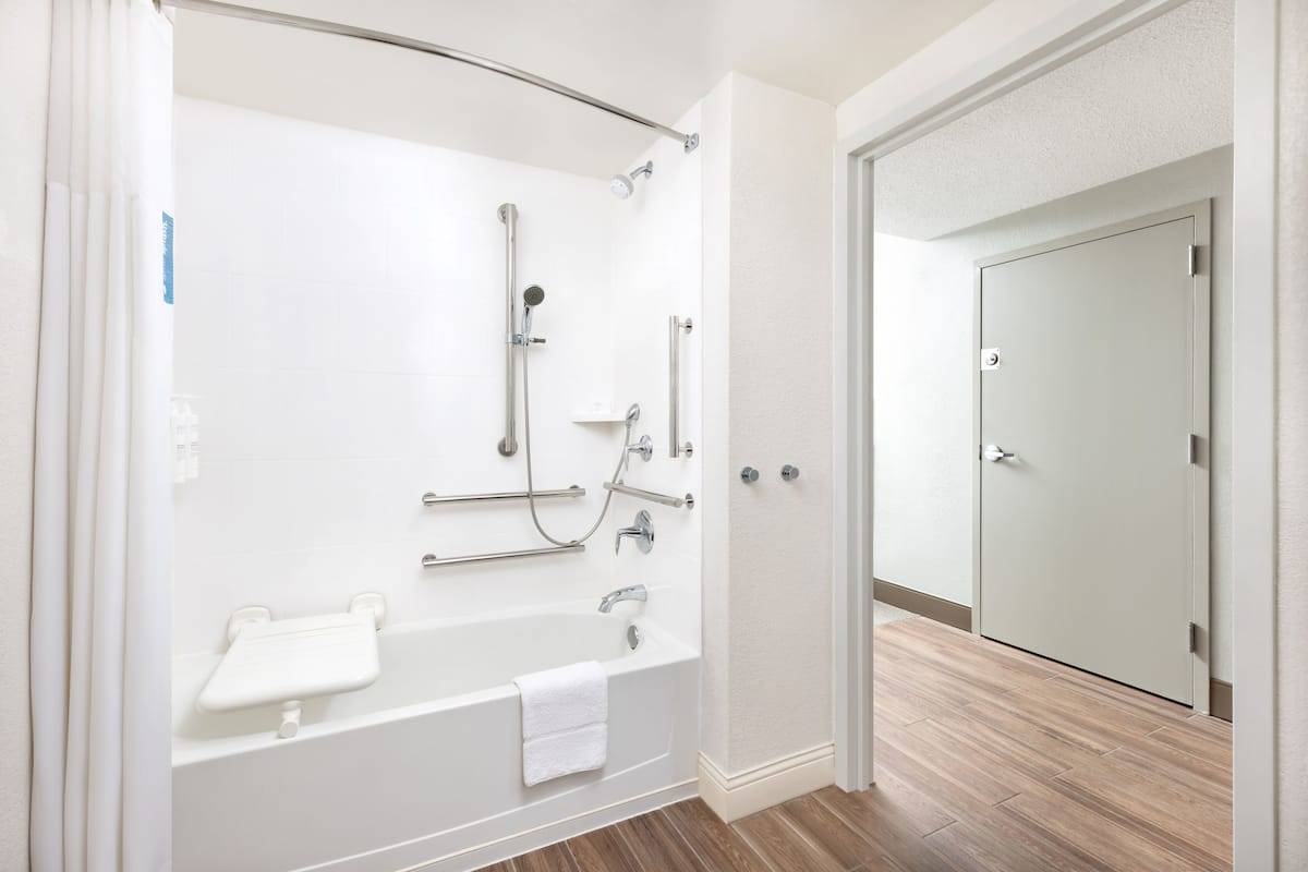 1 queen bed, mobility/hearing accessible, bathtub, non-smoking | bathroom | combined shower/bathtub, free toiletries, hair dryer, towels