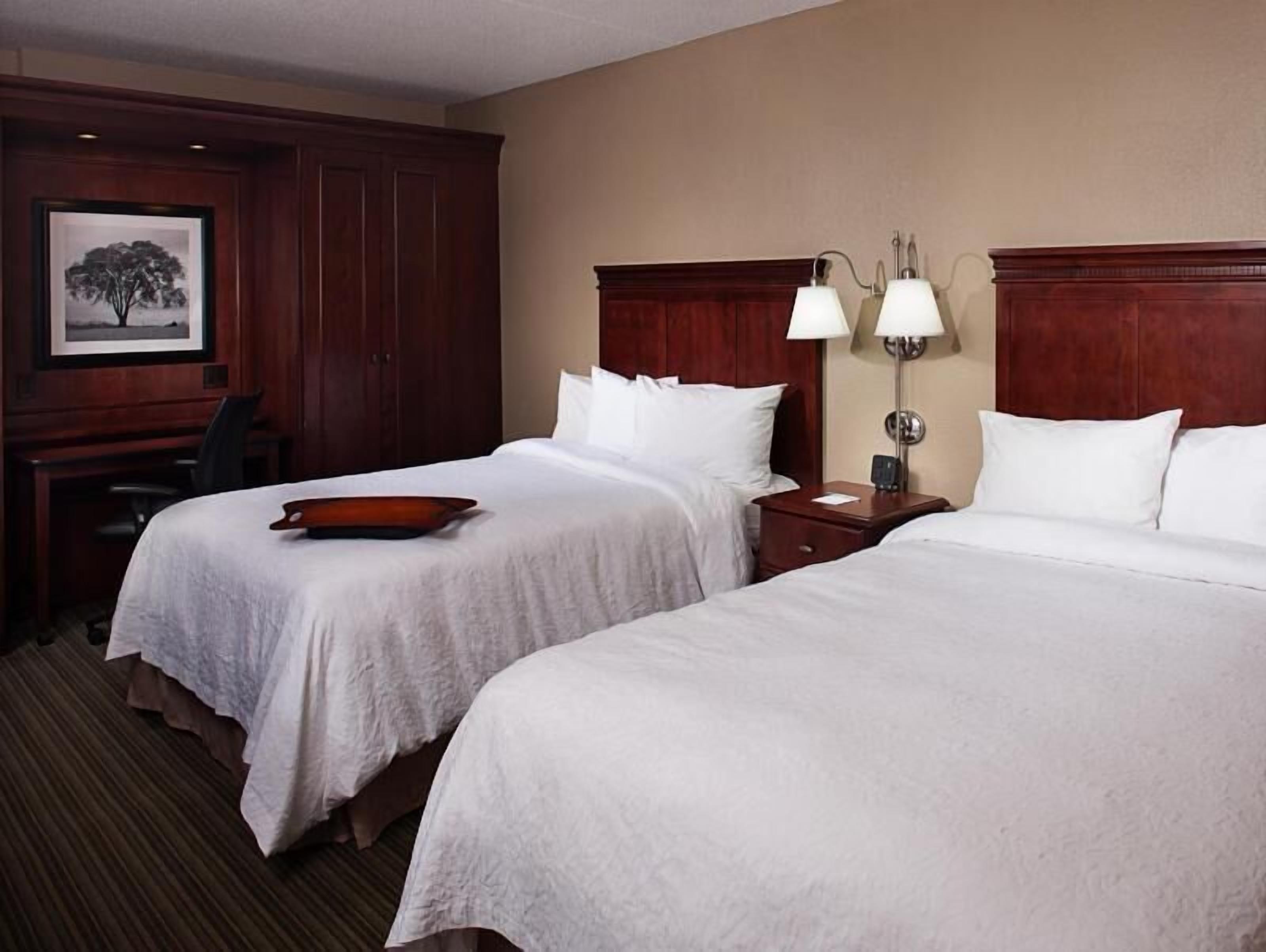 Premium bedding, desk, laptop workspace, blackout drapes