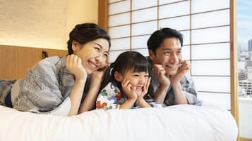 Relax in a serene space with a city view, featuring a traditional Japanese shoji screen and a comfortable bed.