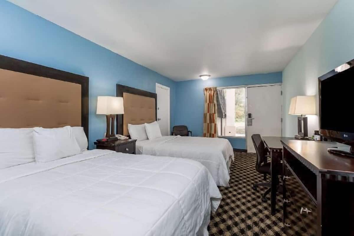 Premium bedding, desk, laptop workspace, iron/ironing board