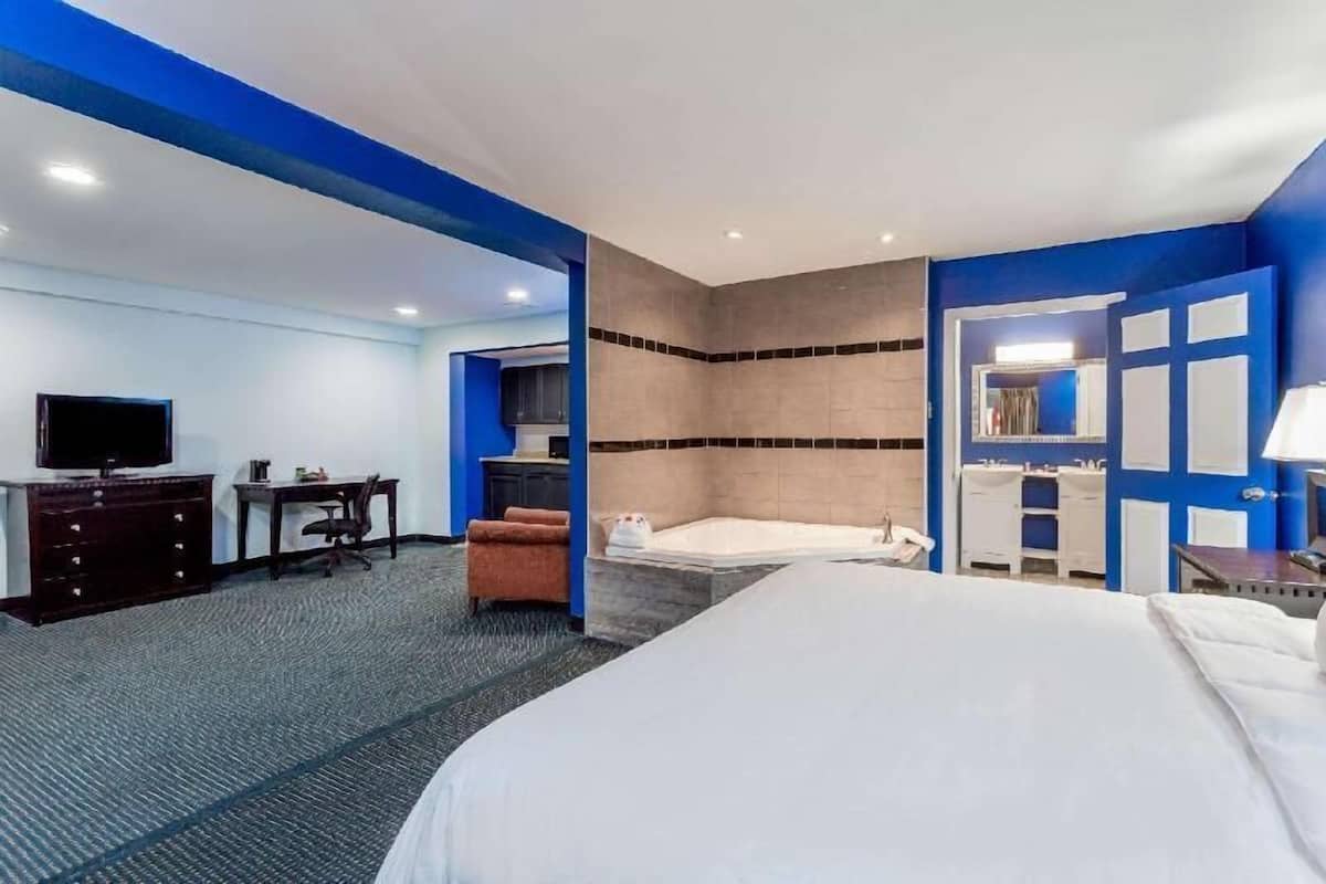 Premium bedding, desk, laptop workspace, iron/ironing board