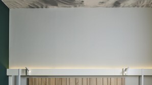 A modern hotel room with two beds, wooden headboard, and a ceiling with a perforated design. - ibis Luxembourg Aéroport (Niederanven)
