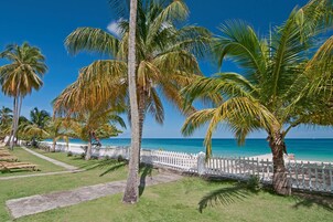 On the beach, white sand, beach towels, windsurfing
