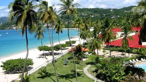 A tropical resort with a beach, palm trees, and a swimming pool. - Radisson Grenada Beach Resort (St. George's)