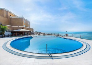 Indoor pool, 2 outdoor pools, pool umbrellas, sun loungers - Radisson Blu Hotel, Kuwait (Salwa)