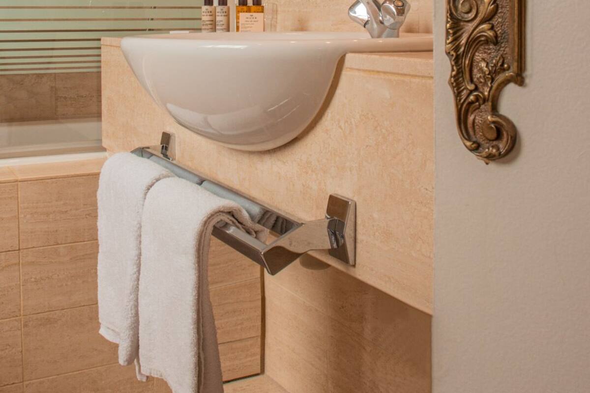 double deluxe room - side street view | living area | tv