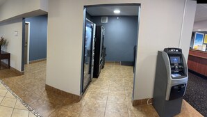A reception area with a counter, seating, and a clock on the wall.
