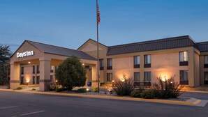 A Days Inn hotel with a flat roof, multiple windows, and a flagpole.