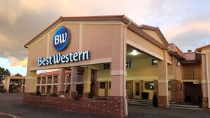 A Best Western hotel with a prominent sign, multiple balconies, and a brick facade. - Best Western Torchlite (Wheatland)