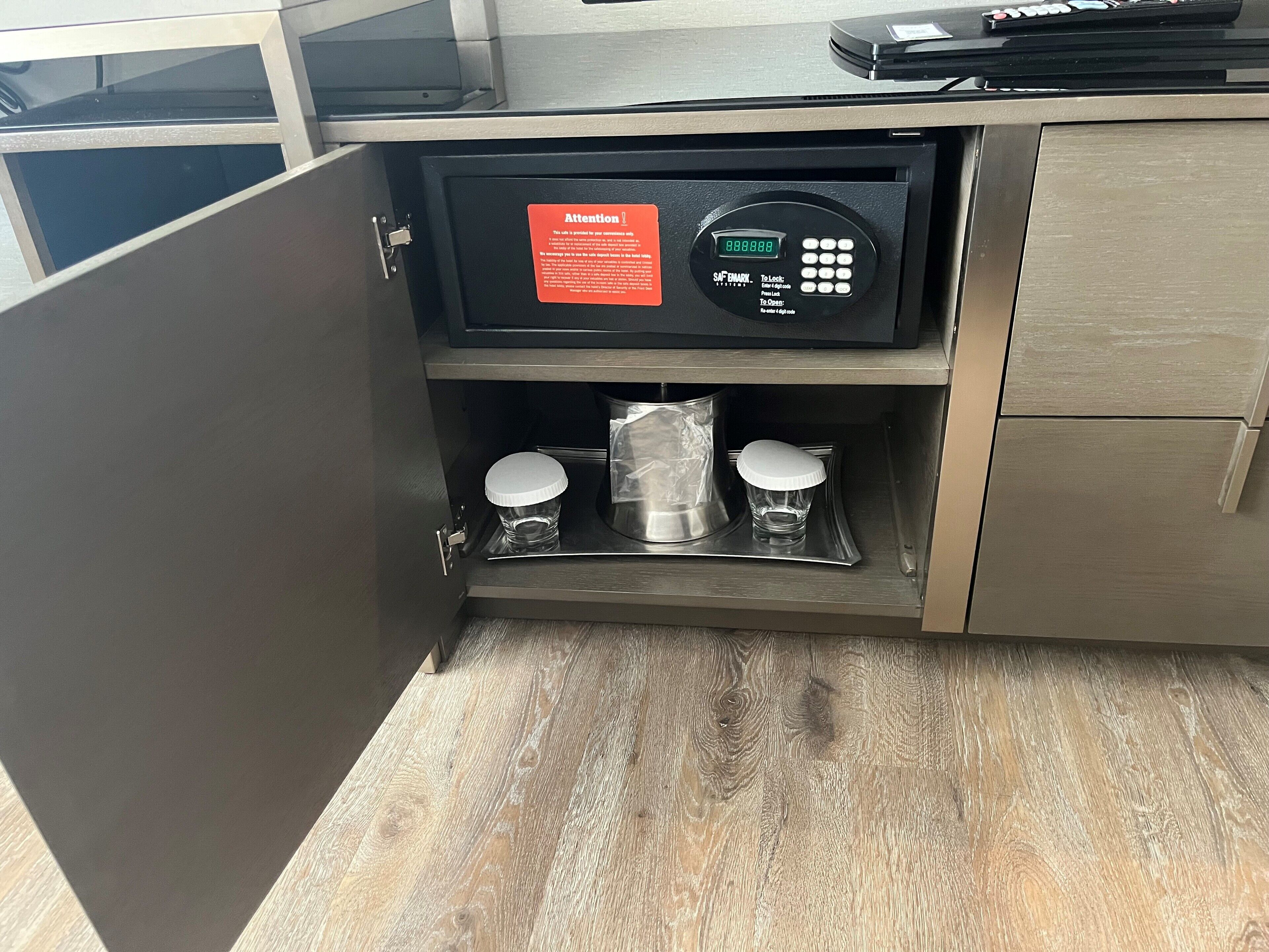 A microwave with a digital display and a keypad, placed on a wooden countertop.