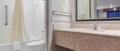 A bathroom with a shower, toilet, and sink.