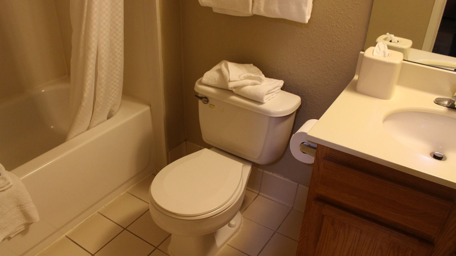 A bathroom with a toilet, a sink, and a bathtub.