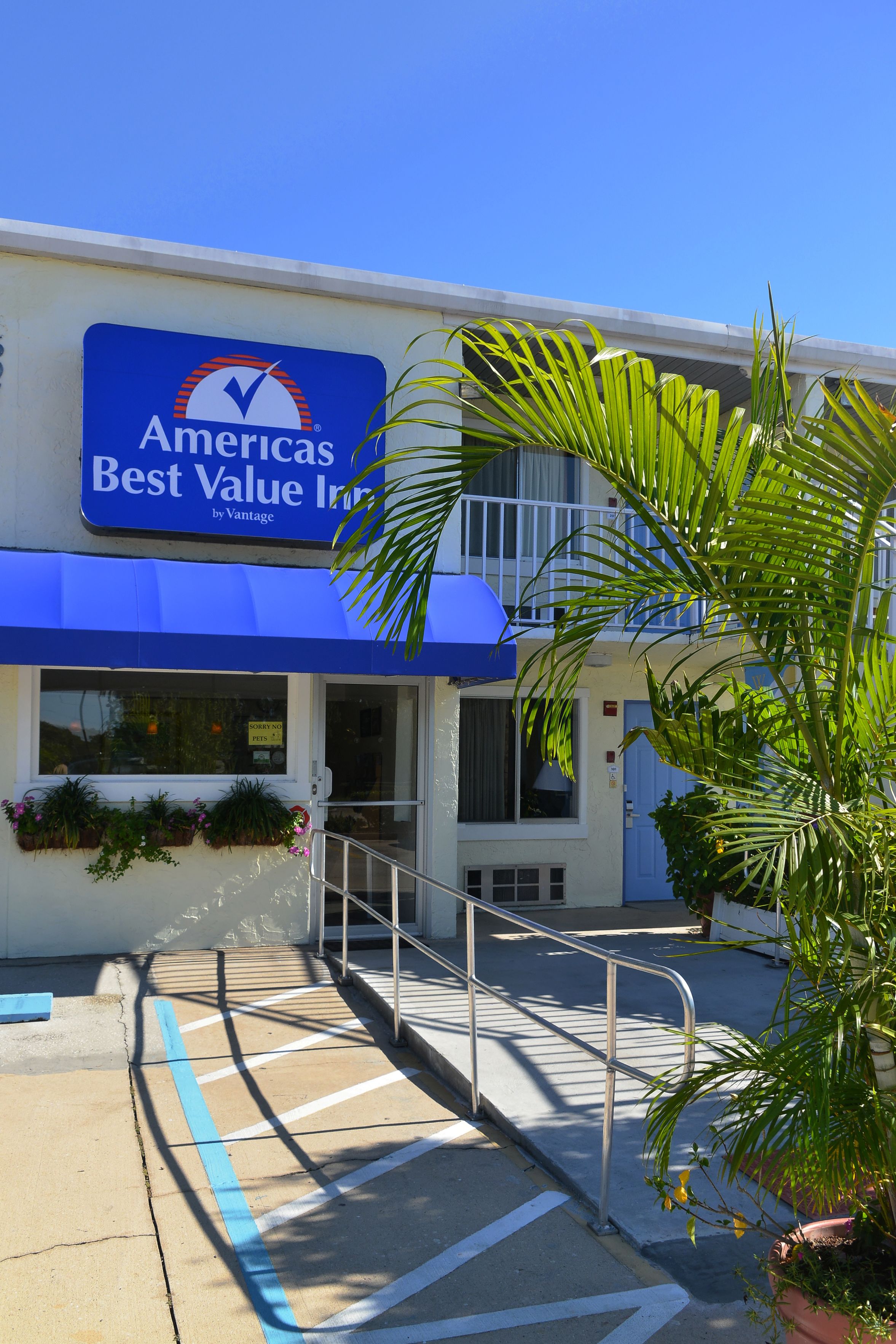 A building with a sign reading "Americas Best Value Inn by Vantage."