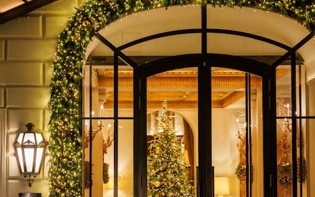 A grand entrance with a Christmas tree and festive decorations.