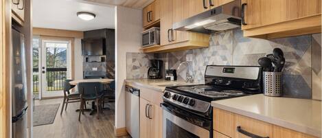 A modern kitchen with wooden cabinets, a built-in microwave, a stove, and a dishwasher.