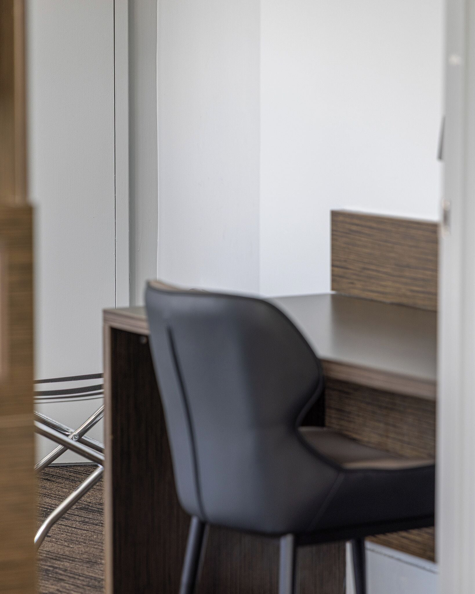 A modern office space with a desk and a chair.