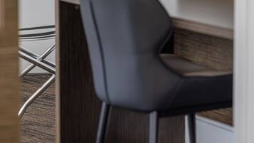 A modern office space with a desk and a chair.