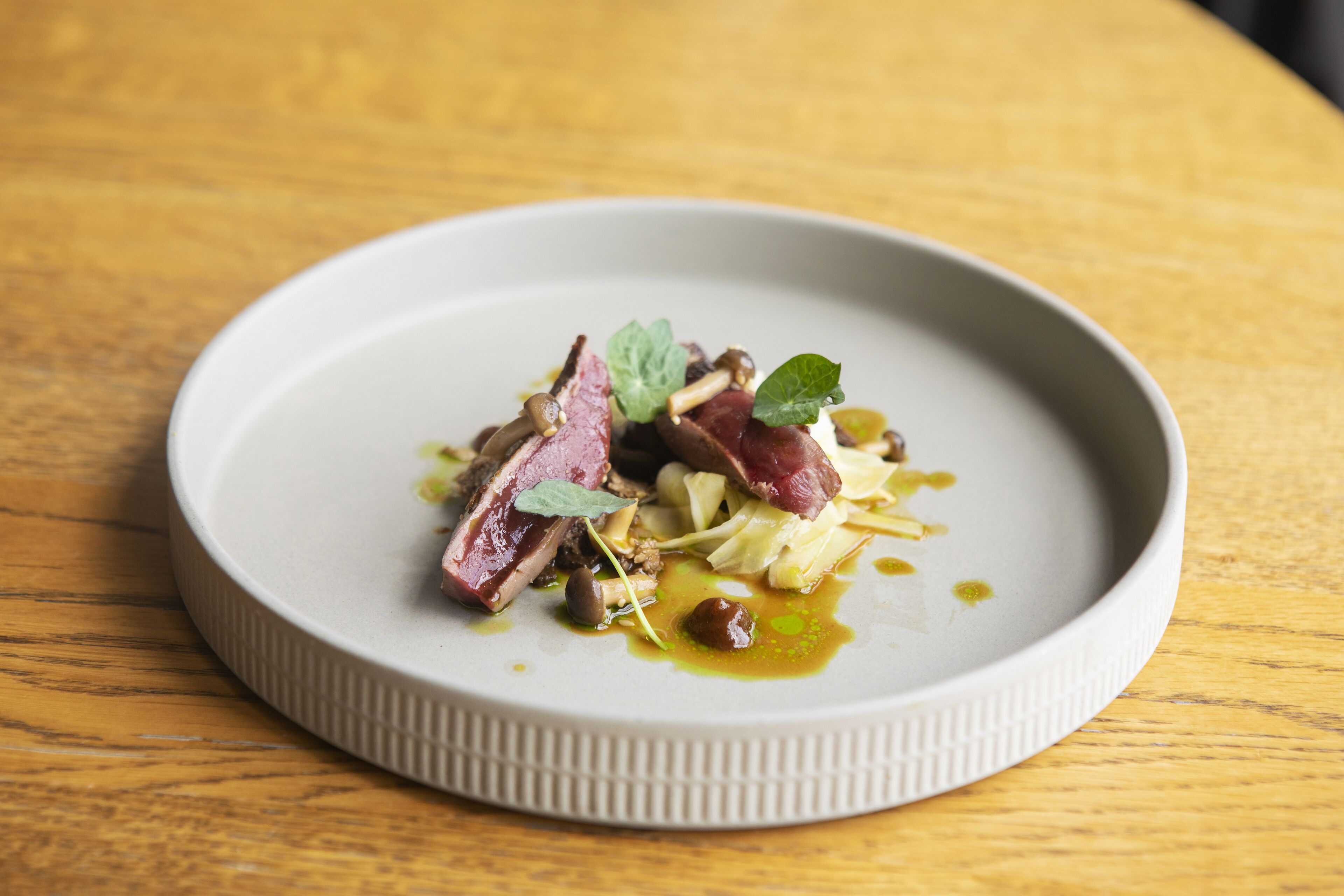 A plate of food on a wooden table.